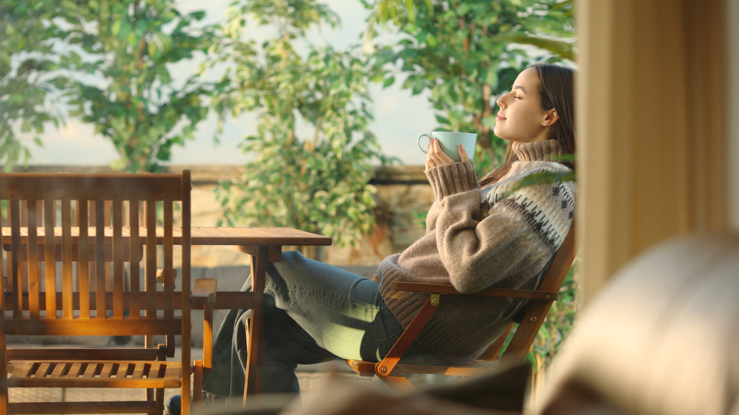 Woman enjoying Xpresso Sip in her coffee having a peaceful morning outdoors