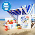 Sip Club drinks with a tote bag on a beach chair by the ocean