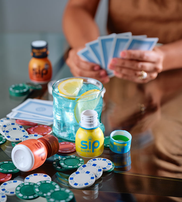 SIP Elixirs with Poker Chips, Playing Cards and Mixed Drink