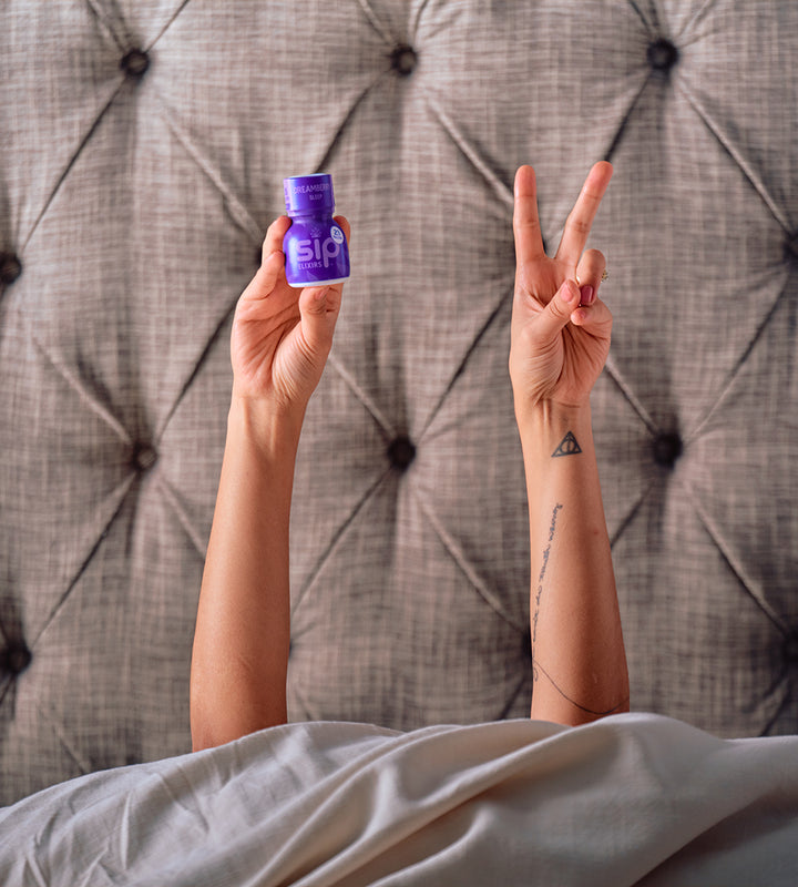 SIP Elixirs - Tattoo'd Woman in Bed with Dream Berry - Sleep bottle, Peace Sign